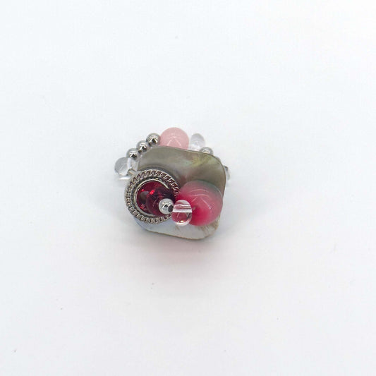 Front view of handmade ring made of seashell, colored glaze, natural stone