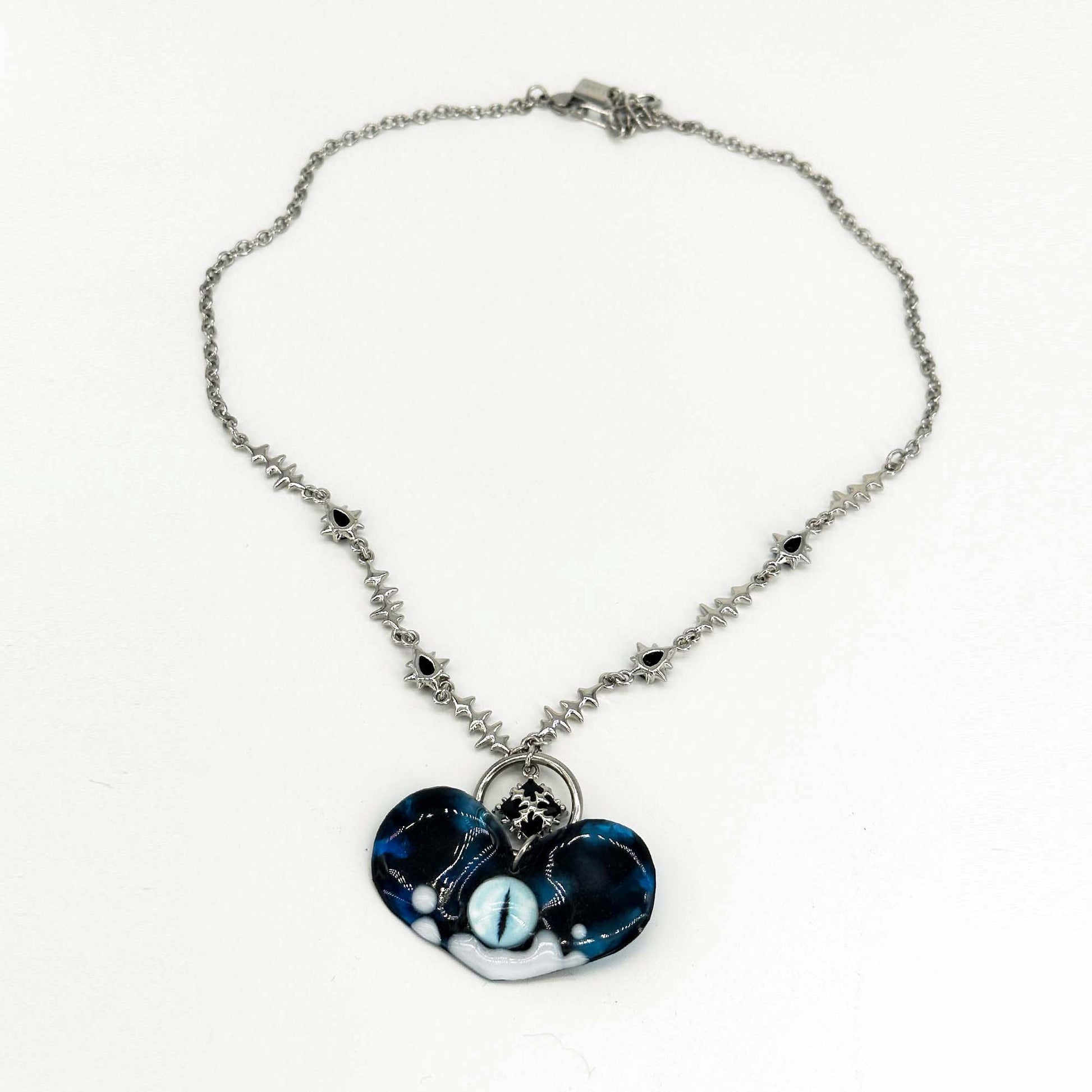 Handmade necklace made of resin in the shape of a heart and eye elements