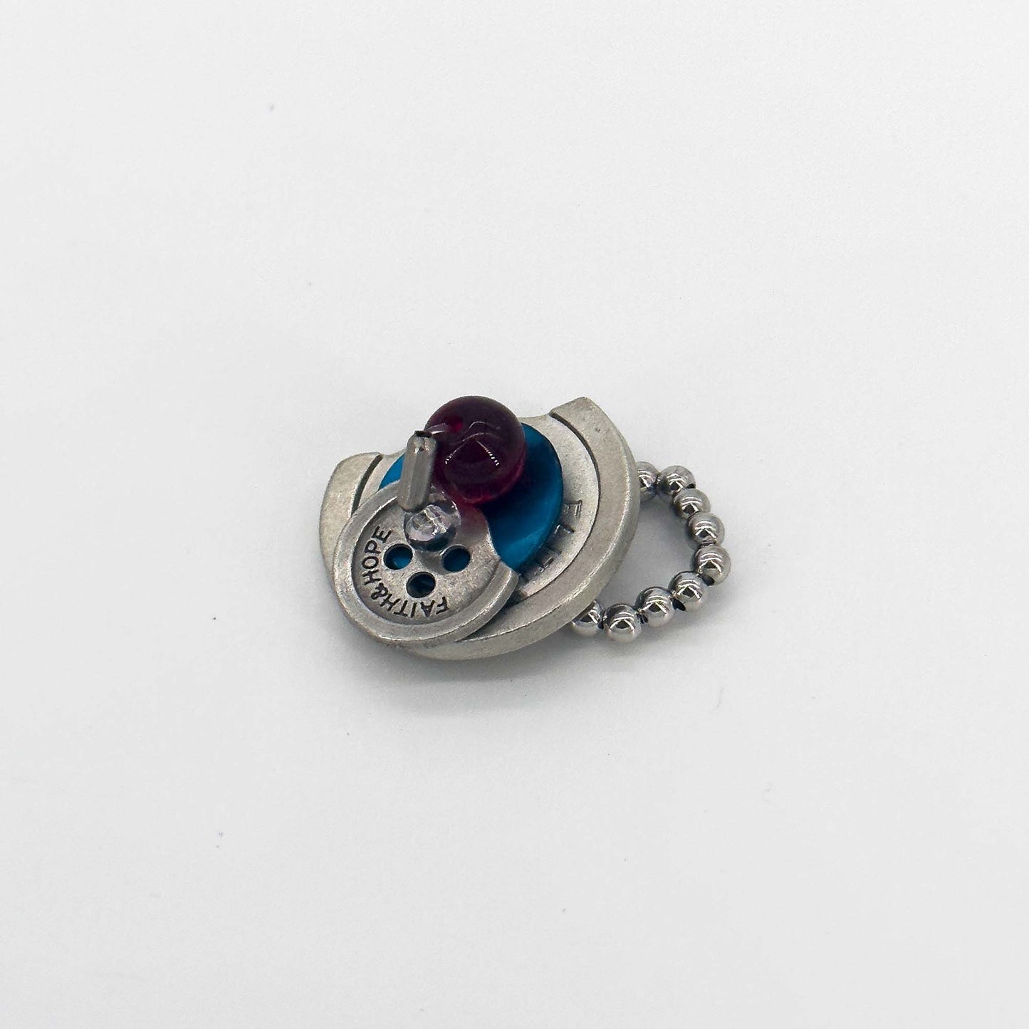Side view of a handmade ring with button elements made of seashell, colored glaze