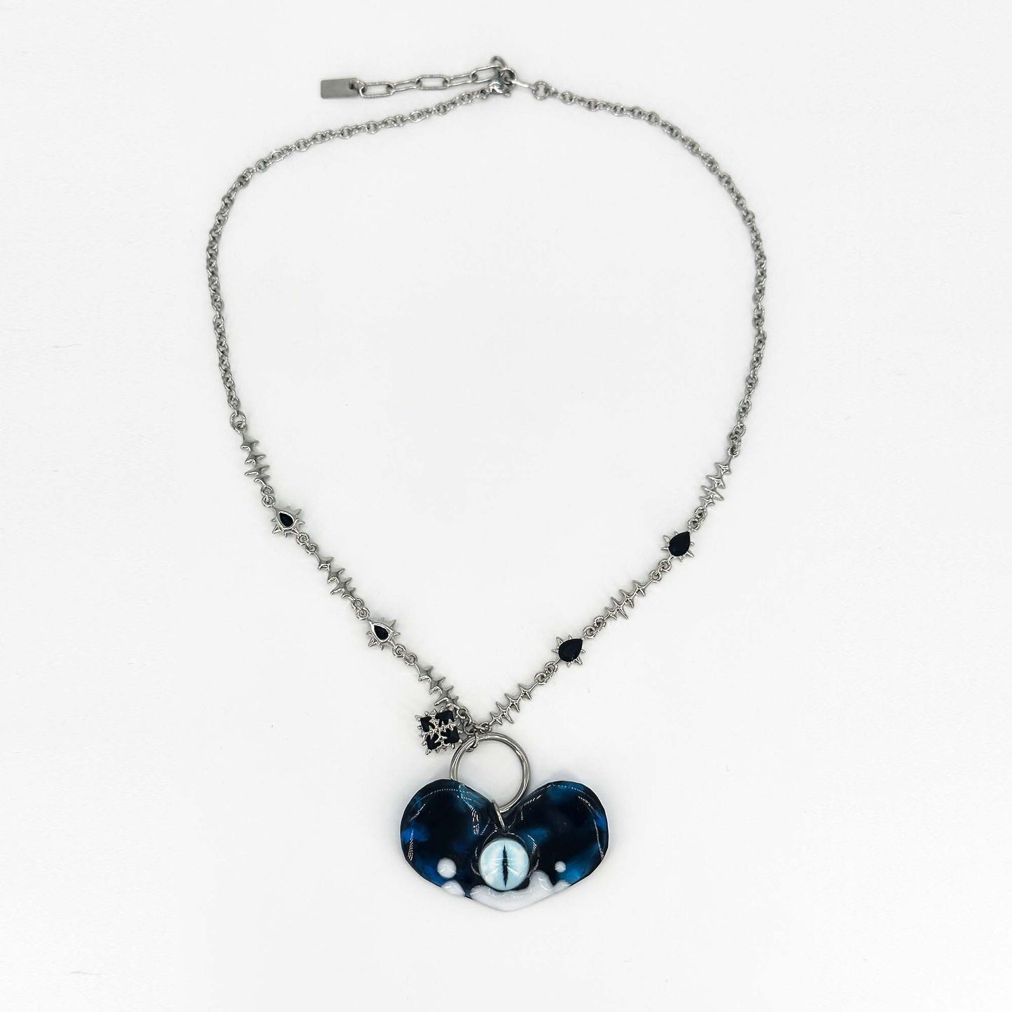 Handmade necklace made of resin in the shape of a heart and eye elements