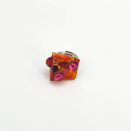 Cheese shape made of resin, eye element handmade ring front view