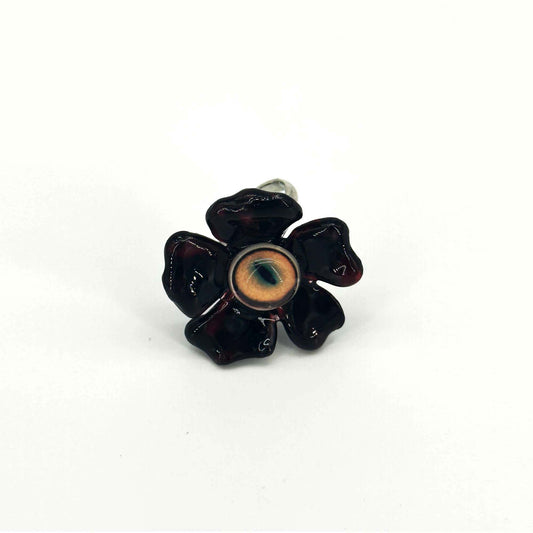 Front view of handmade ring with flower and eye elements