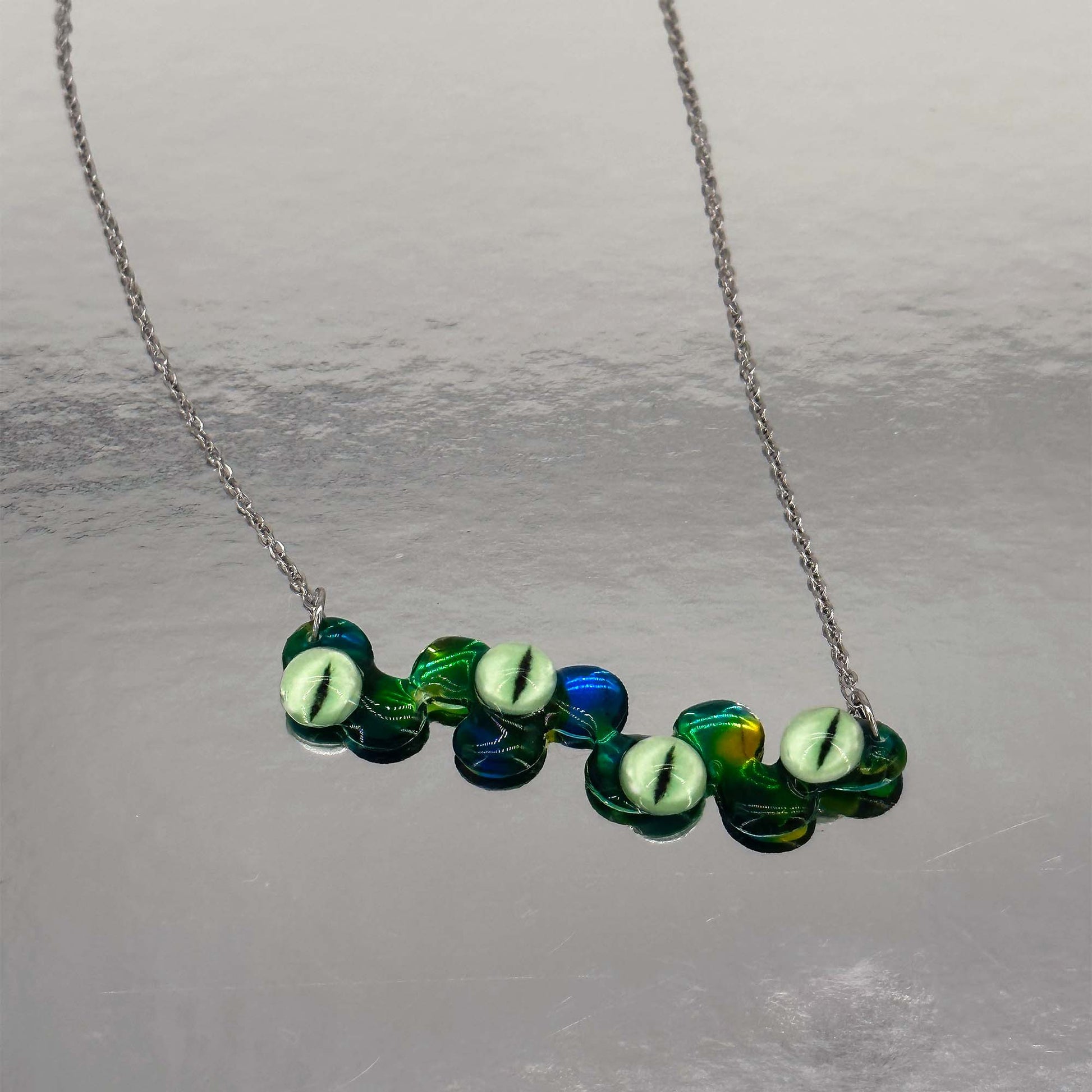 Handmade necklace with green eye elements made of resin